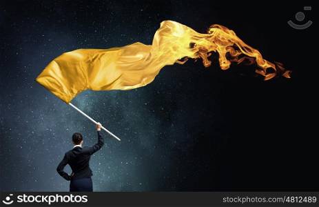 Woman waving yellow flag. Young determined businesswoman with yellow flag in hands