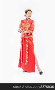 Woman wear Cheongsam suit and black shoe ready to give the gift money to relative