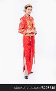 Woman wear Cheongsam suit promote to welcome traveller shopping in chinese new year