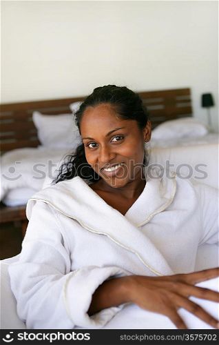 Woman wearing a bath robe in bed