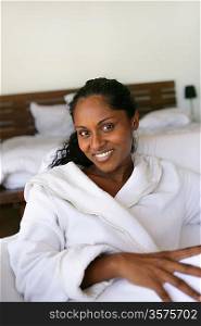 Woman wearing a bath robe in bed