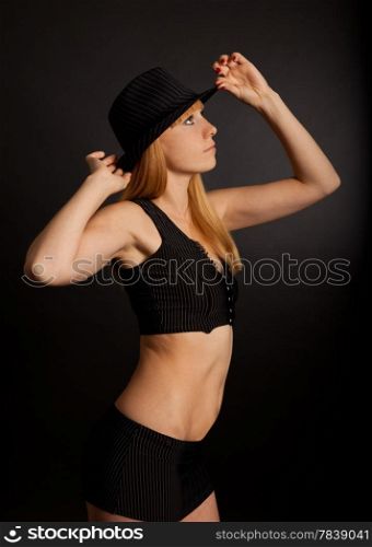 Woman wearing a hat on a black background