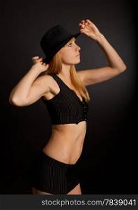 Woman wearing a hat on a black background