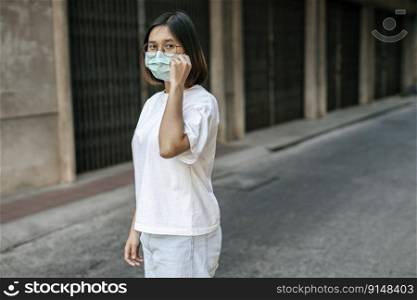  Woman wearing a mask on the street. Selective focus.