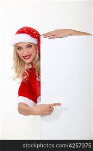 woman wearing a Santa suit and holding an advertising board