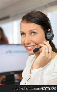 Woman wearing a telephone headset in an office