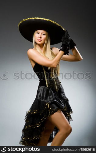 Woman wearing black sombrero dancing