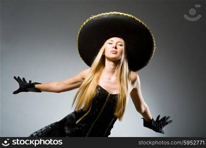 Woman wearing black sombrero dancing