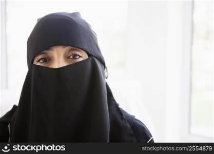 Woman wearing black veil indoors (high key)