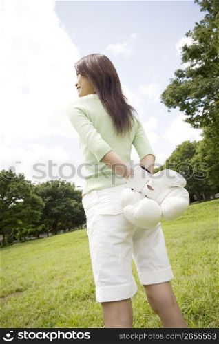 Woman wearing boxing gloves outside