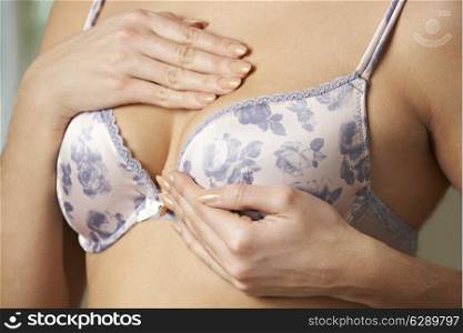 Woman Wearing Bra Examining Breast