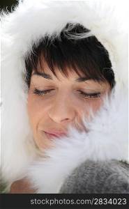 Woman wearing coat with furry hood