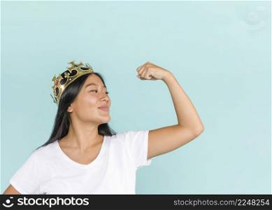 woman wearing crown raising her arm