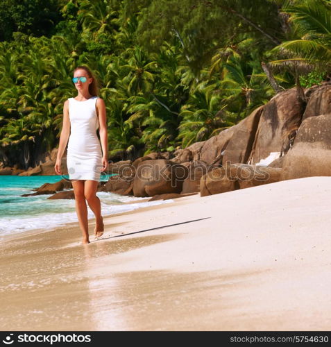 Woman wearing dress on beach Anse Intendance at Seychelles, Mahe