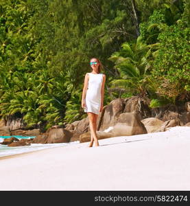 Woman wearing dress on beach Anse Intendance at Seychelles, Mahe