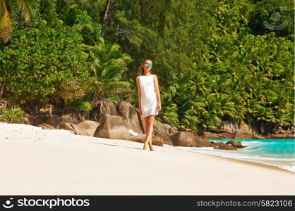 Woman wearing dress on beach Anse Intendance at Seychelles, Mahe