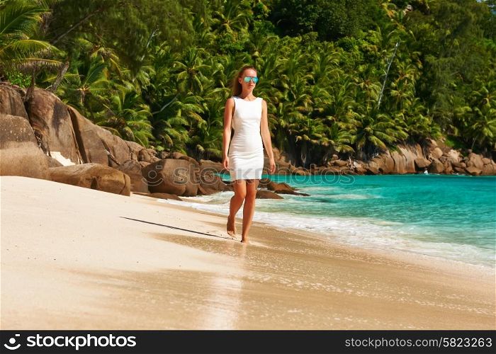 Woman wearing dress on beach Anse Intendance at Seychelles, Mahe