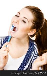 Woman wearing dressing gown brushing cleaning teeth. Funny girl with toothbrush. Oral hygiene. Isolated on white. Woman brushing cleaning teeth.