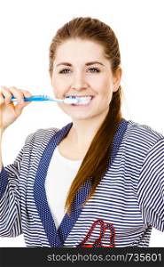 Woman wearing dressing gown brushing cleaning teeth. Smiling positive girl with toothbrush. Oral hygiene. Isolated on white. Woman brushing cleaning teeth.