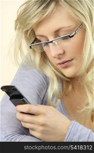Woman wearing glasses sending a text message
