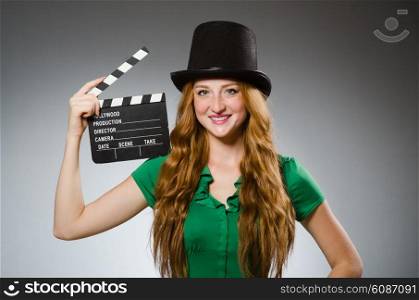 Woman wearing green dress with movie board