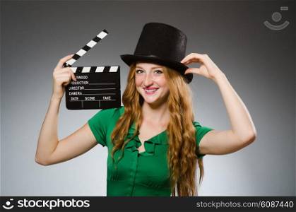 Woman wearing green dress with movie board