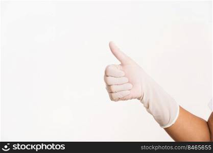 Woman wearing hand to white rubber latex surgical medical glove for doctor with thumb up finger gesturing, studio shot isolated on white background, Hospital medical infection control concept
