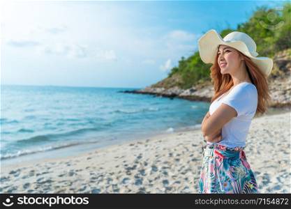 woman wearing hat standing on the sea beach