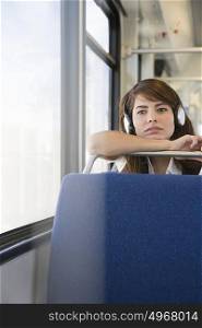 Woman wearing headphones on train