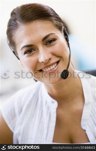 Woman wearing headset indoors smiling