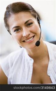 Woman wearing headset indoors smiling