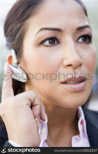 Woman wearing headset outdoors (selective focus)