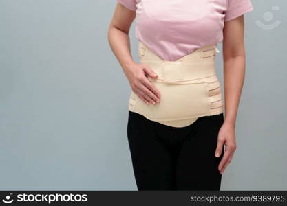 woman wearing lumbar support belts. pregnant and postnatal lumbar brace after surgery