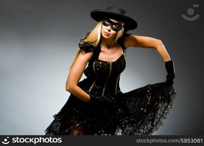 Woman wearing mask against dark background