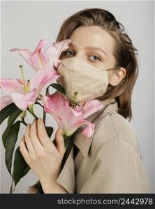 woman wearing mask holding bouquet flowers