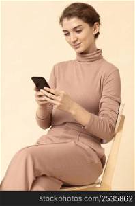 woman wearing monochrome clothes using mobile phone