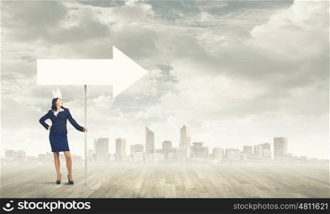 Woman wearing paper crown. Young businesswoman in paper crown carrying blank banner. Place for text