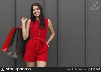 woman wearing red clothes holding bags