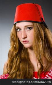 Woman wearing red fez hat