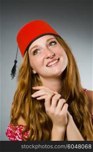 Woman wearing red fez hat
