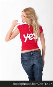 Woman wearing red shirt with YES word on it