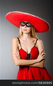 Woman wearing red sombrero and mask