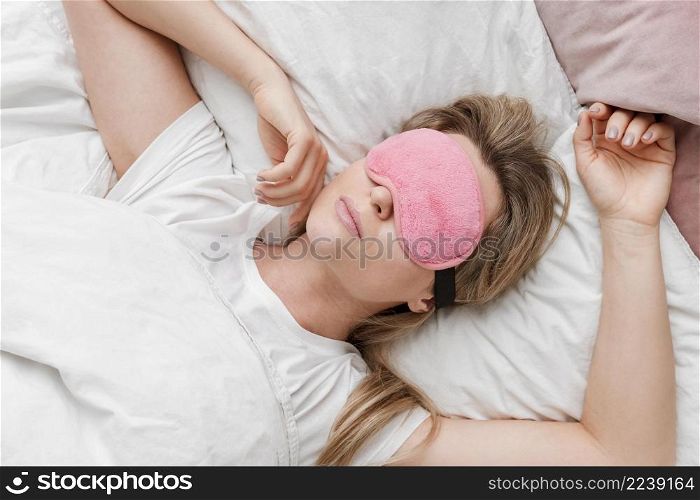 woman wearing sleep mask her eyes top view