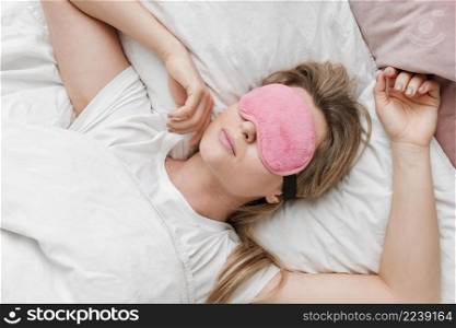 woman wearing sleep mask her eyes top view