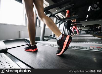 woman wearing sneakers using treadmill. Resolution and high quality beautiful photo. woman wearing sneakers using treadmill. High quality and resolution beautiful photo concept