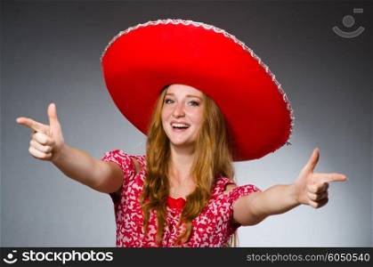 Woman wearing sombrero hat in funny concept