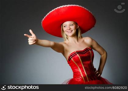 Woman wearing sombrero hat in funny concept