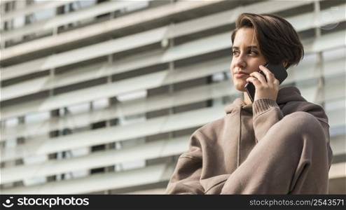 woman wearing sportswear talking phone with copy space