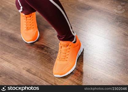 Woman wearing sportswear trainers red shoes, comfortable footwear perfect for workout and training.. Woman wearing sportswear trainers shoes