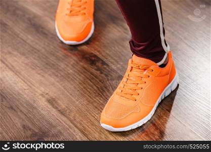 Woman wearing sportswear trainers red shoes, comfortable footwear perfect for workout and training.. Woman wearing sportswear trainers shoes